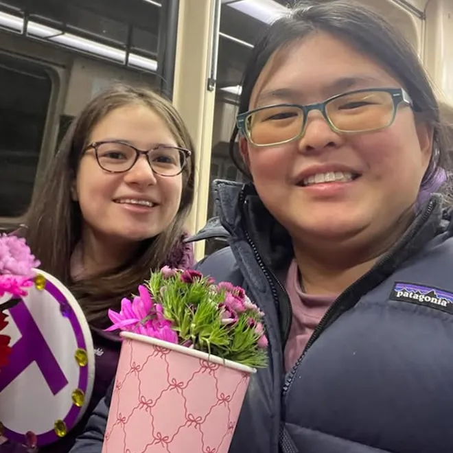 Pari Kim and Tina Zhu Xi Caruso smiling together from Love on the Spectrum