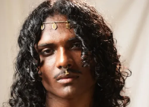 A young Indian musician performing.