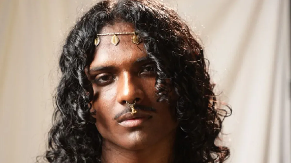 A young Indian musician performing.