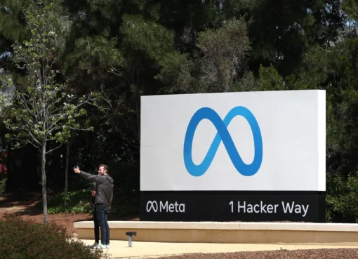 The Meta logo on a glass building reflecting the sky