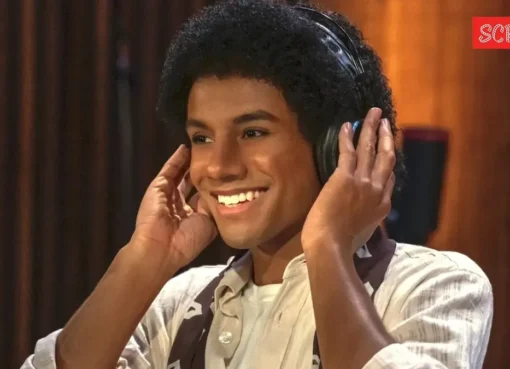 A person dressed as Michael Jackson performing on a brightly lit stage with gold accents.