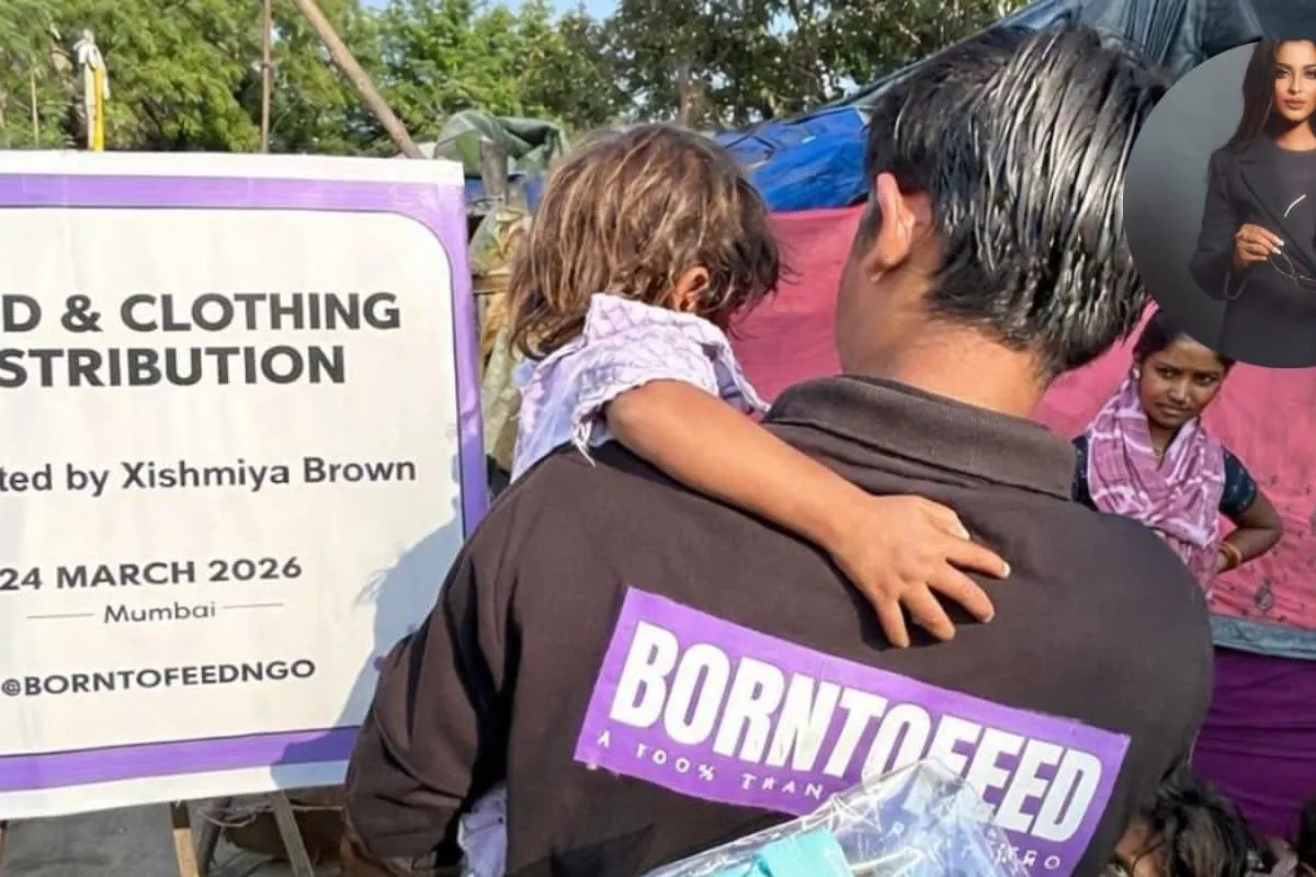 Model Xishmiya Brown smiling while distributing food and clothes to children in Mumbai.