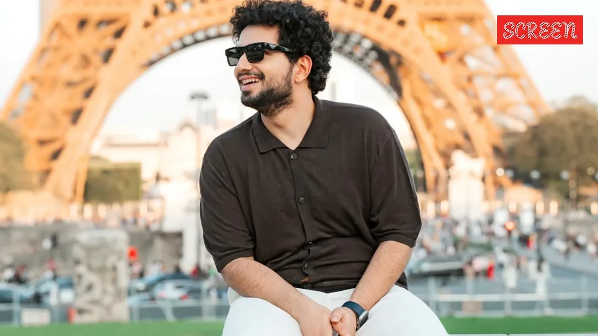 Comedian Samay Raina speaking thoughtfully into a microphone during an interview.