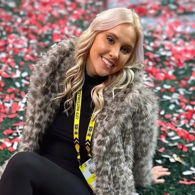 A professional setting with microphones and reporters.