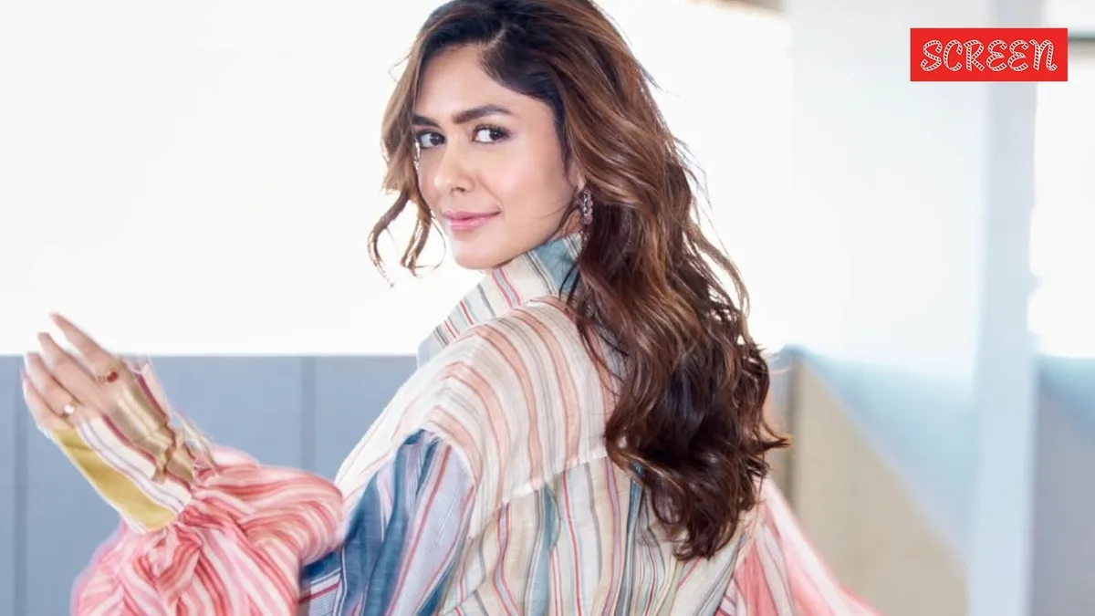 Mrunal Thakur smiling on a film set.