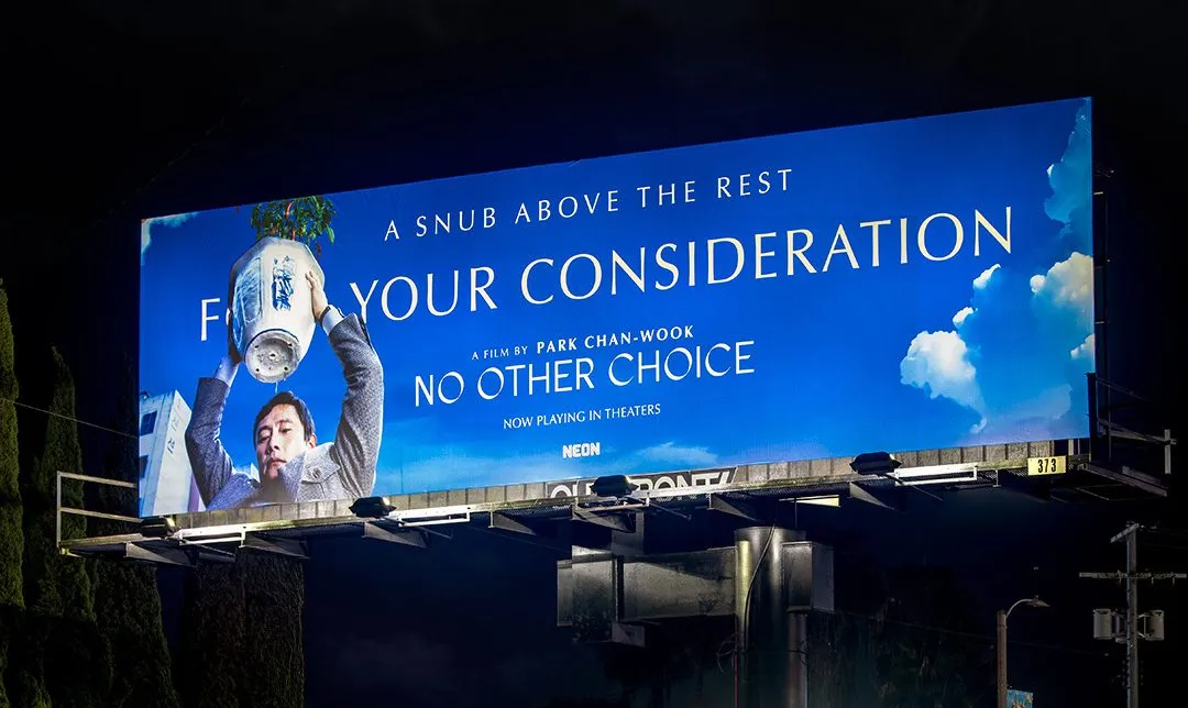 A glowing neon sign in a dark room representing the Neon film studio brand.