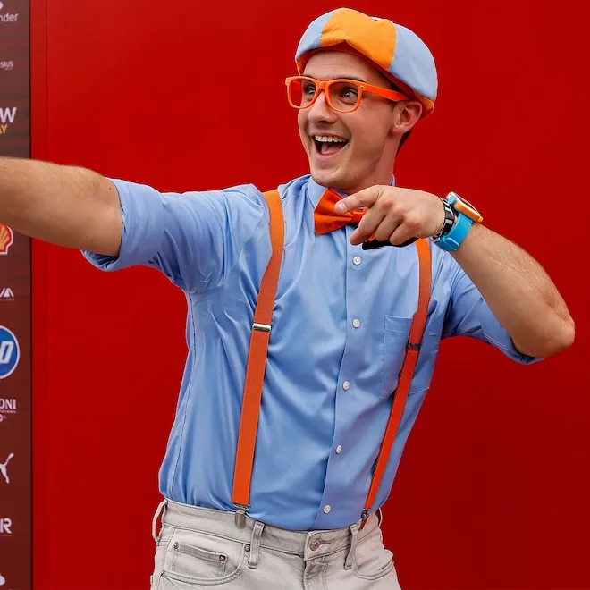 Blippi smiling in his signature orange and blue outfit.