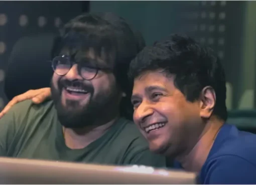 Pritam looking emotional and reflective during a live performance on stage.