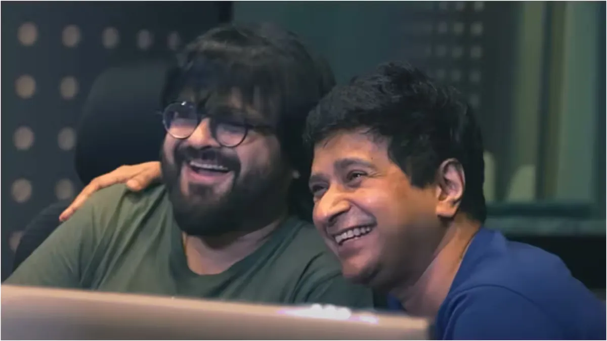 Pritam looking emotional and reflective during a live performance on stage.