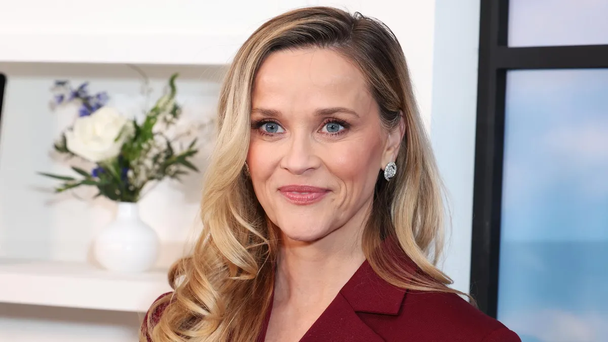 Reese Witherspoon looking confident in a bright, professional setting
