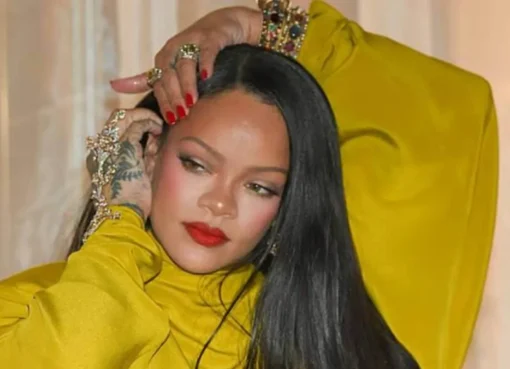 Rihanna striking a dance pose with hand gestures.