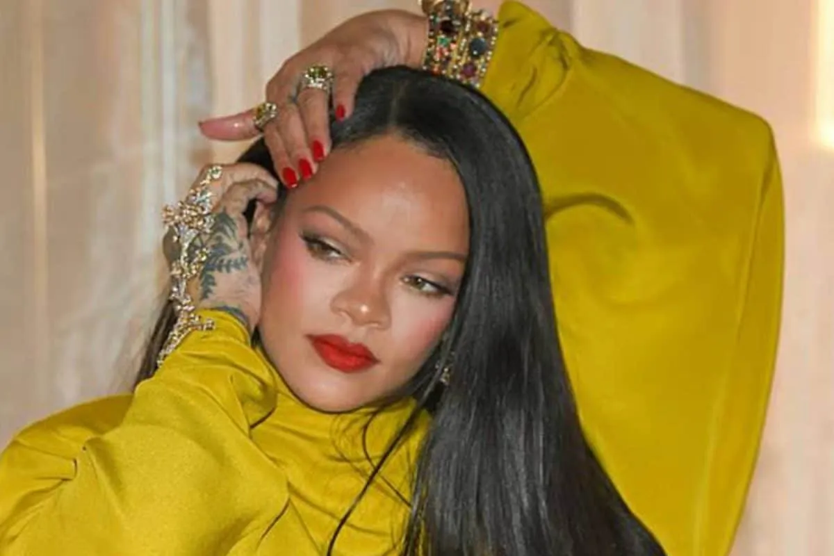 Rihanna striking a dance pose with hand gestures.