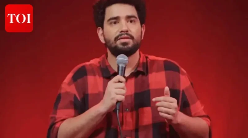 Comedian Samay Raina performing live on stage with a microphone.