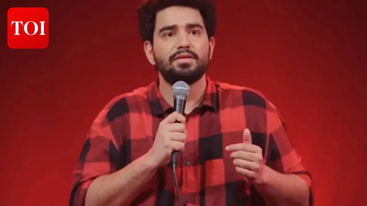 Comedian Samay Raina performing live on stage with a microphone.