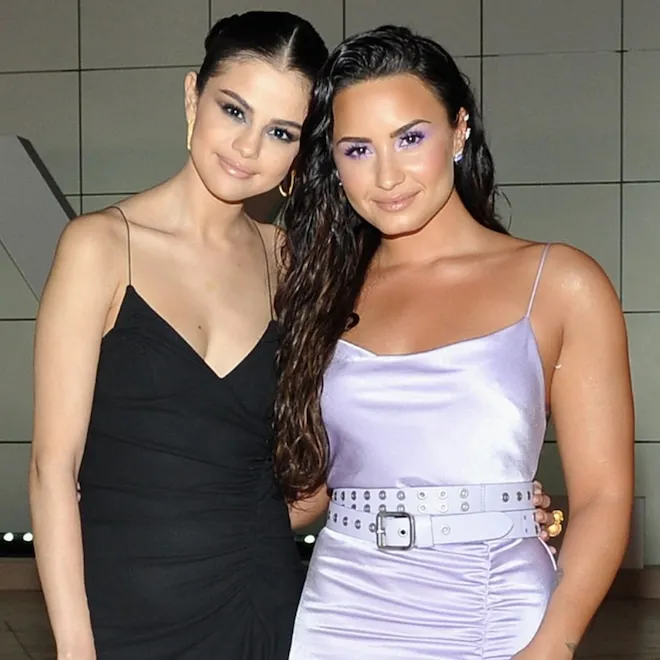 Selena Gomez and Demi Lovato smiling together.