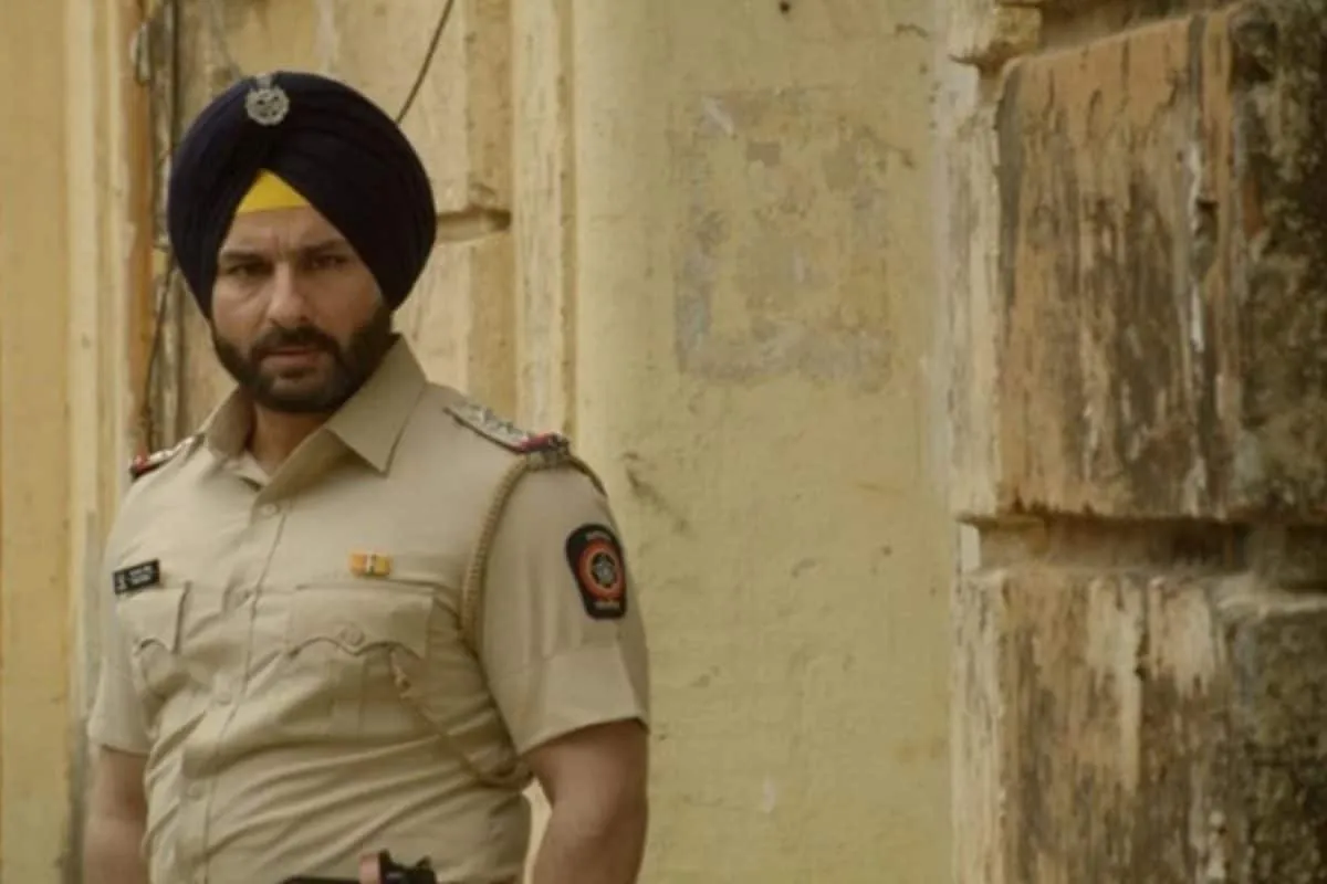 Saif Ali Khan in a cop uniform, looking serious.