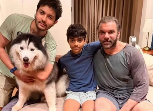 Sohail Khan smiling happily with his two sons, Nirvaan and Yohan, and a pet husky.
