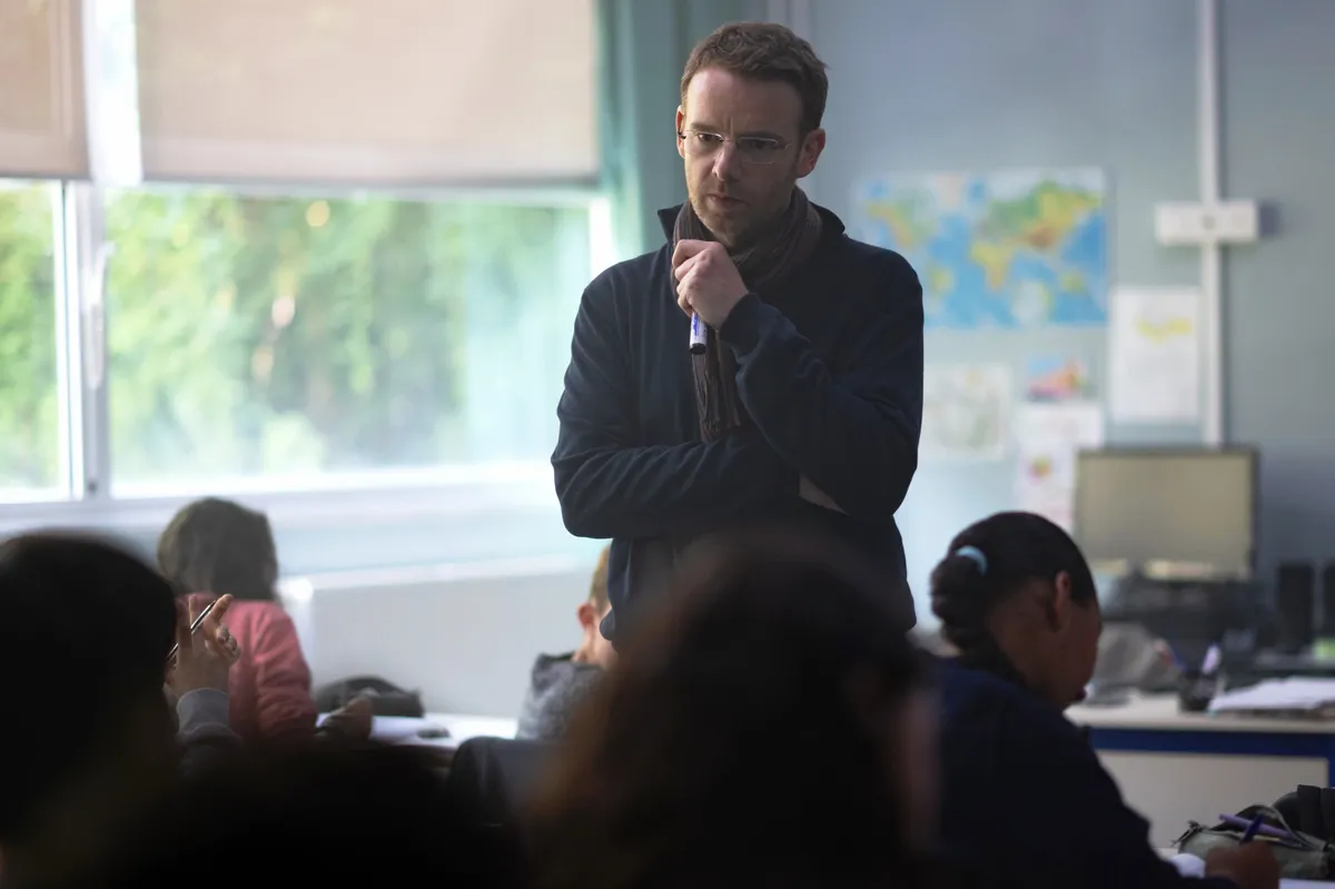 Image of Antoine Reinartz, an actor, possibly from a film still, looking serious.