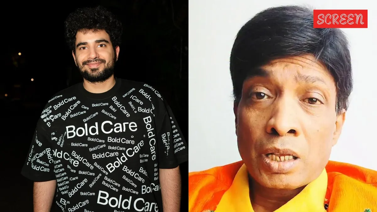 Samay Raina laughing during a stand-up comedy set with dark lighting