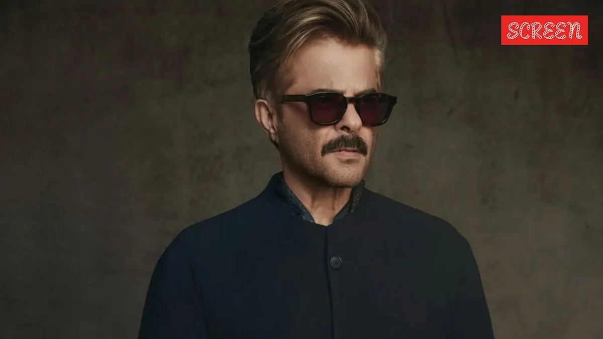 Anil Kapoor looking stylish in a suit at an event.