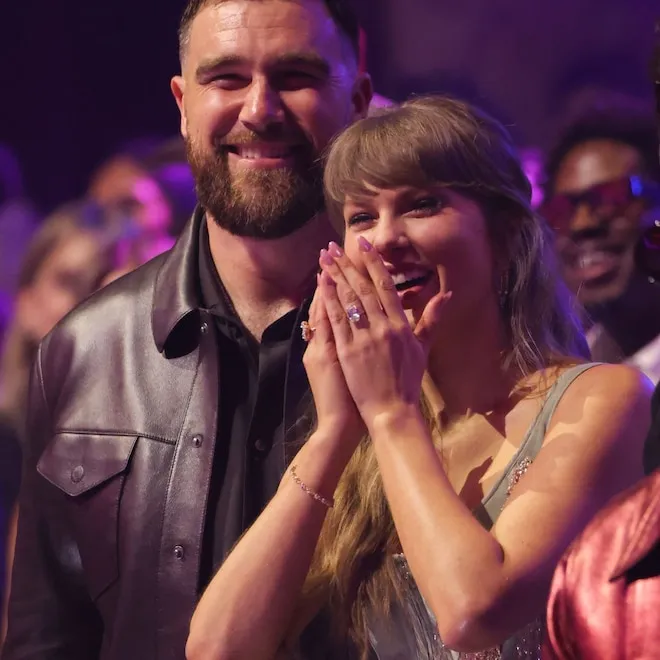 A close-up of a sparkling engagement ring on a finger.