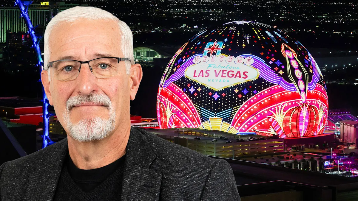 The glowing Sphere building in Las Vegas at night with colorful lights.