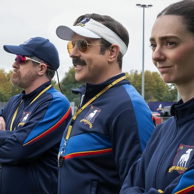 A bright yellow sign that says Believe taped to a locker room wall.