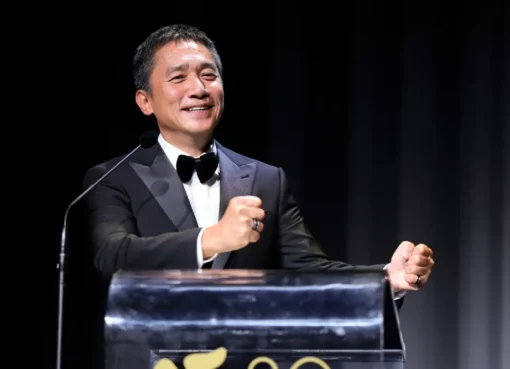 Close-up photo of actor Tony Leung Chiu-wai smiling subtly.