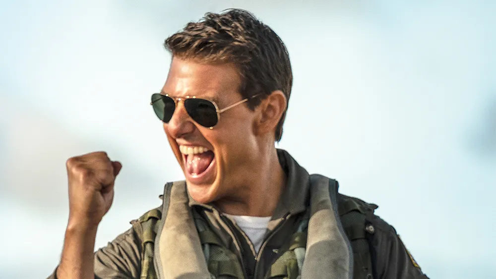 Tom Cruise as Maverick in a fighter jet cockpit, looking intense.