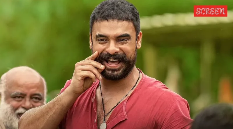 Tovino Thomas, a prominent South Indian actor, smiling candidly at an event.