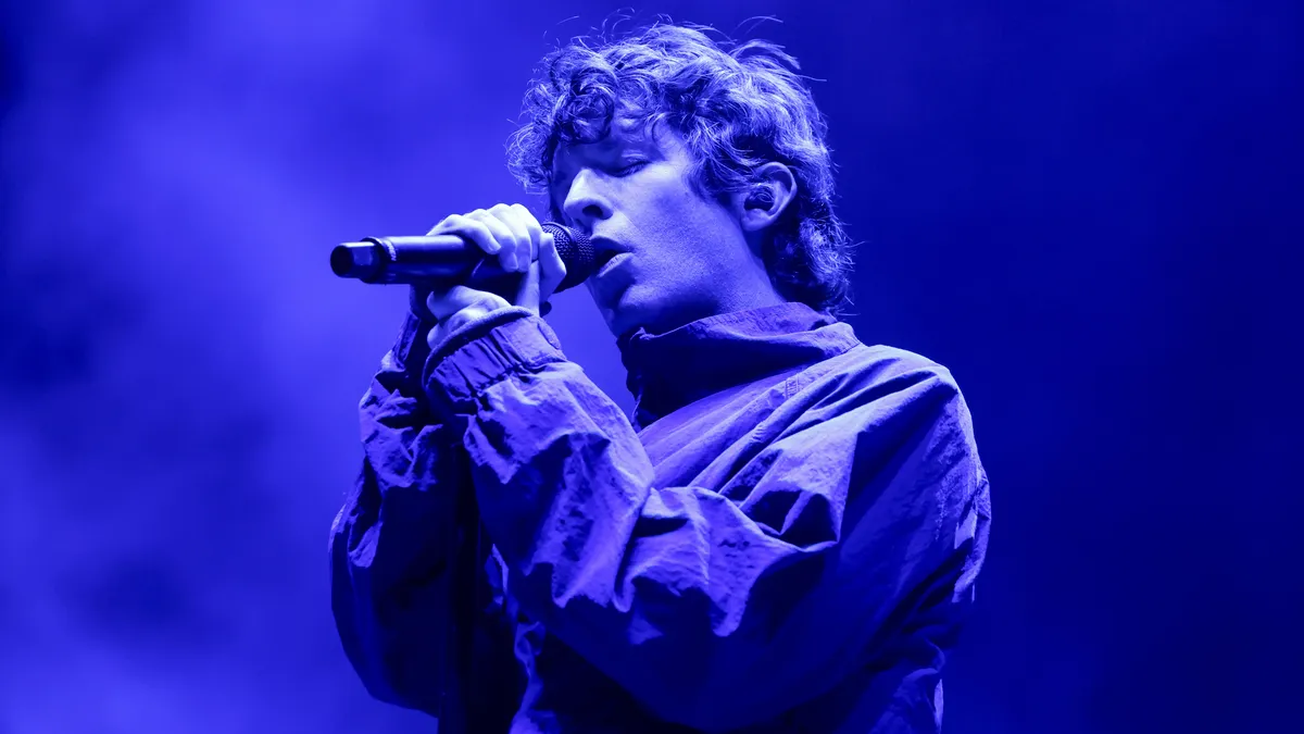 A screen at Coachella showing a man's face speaking.
