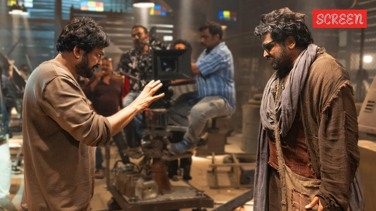 Vijay Sethupathi smiling next to director Puri Jagannadh during a film event.
