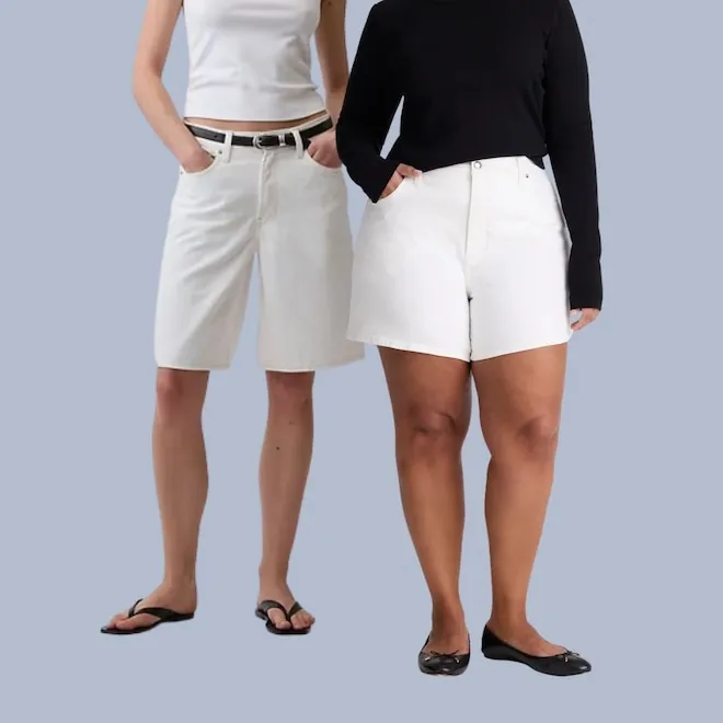 A person wearing stylish white denim shorts.