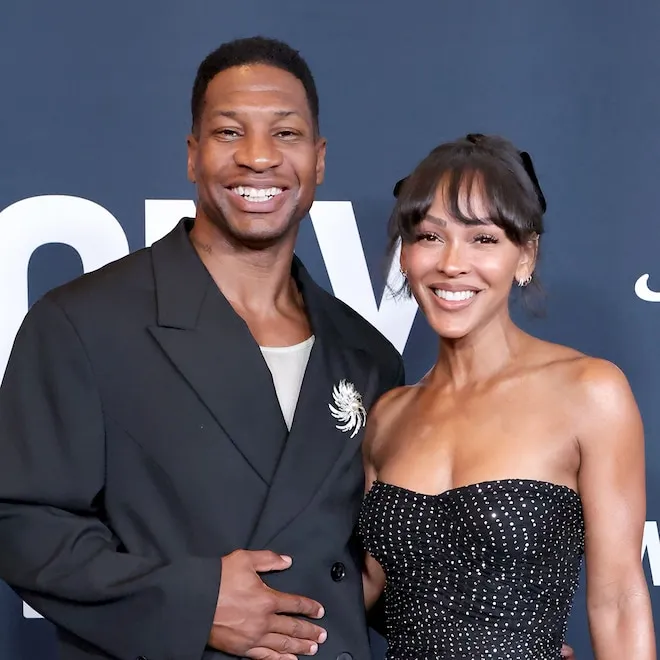 Meagan Good and Jonathan Majors posing together at an event.