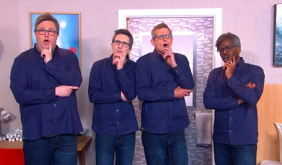 A still image from a comedy sketch showing multiple actors dressed as Louis Theroux in a hotel room.