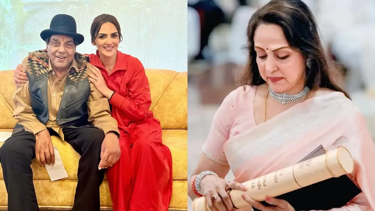 Hema Malini gracefully accepting the Padma Vibhushan award with a warm smile, likely for Dharmendra, at a formal ceremony.