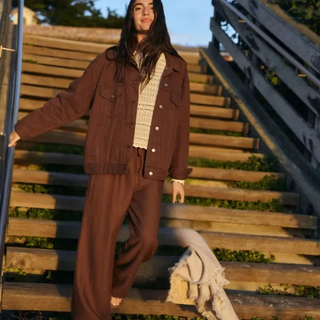 A person wearing light-colored, wide-leg linen pants looking breezy and comfortable.