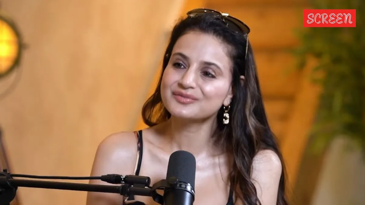 Ameesha Patel looking confident and speaking at an event.