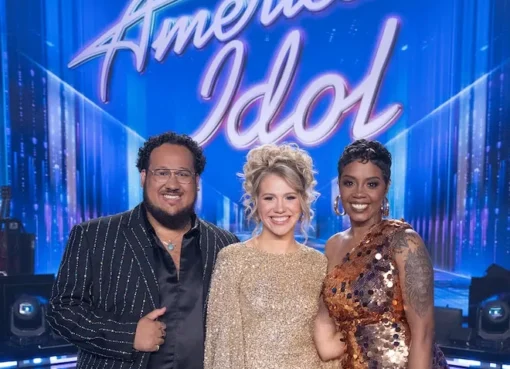 A group of diverse singers performing on a brightly lit stage.