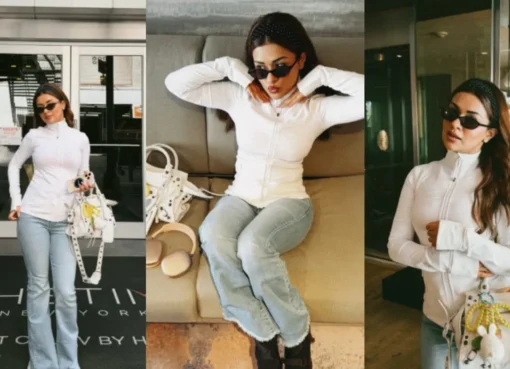 Avneet Kaur in a white top and light bootcut jeans, carrying an oversized white handbag with charms in New York City.