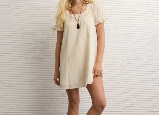 Olivia Rodrigo wearing a babydoll dress with a nostalgic, sweet aesthetic.
