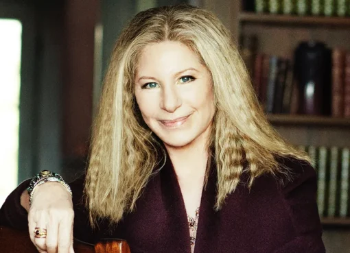 Barbra Streisand smiling elegantly at a formal event.
