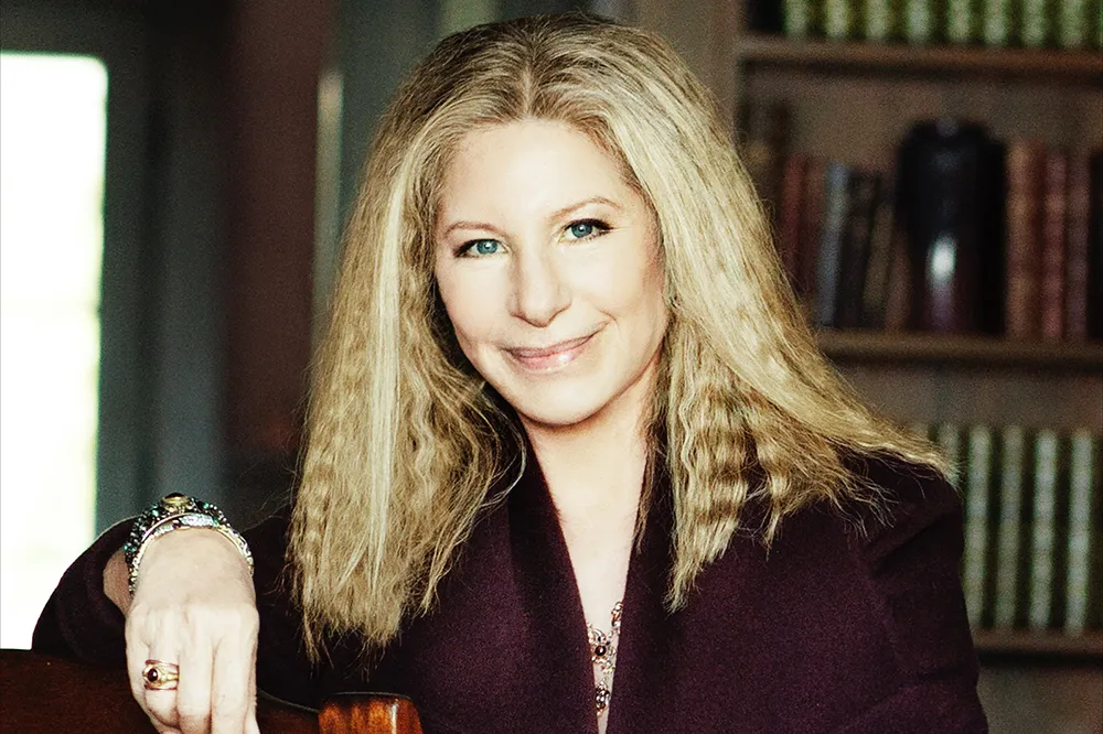 Barbra Streisand smiling elegantly at a formal event.