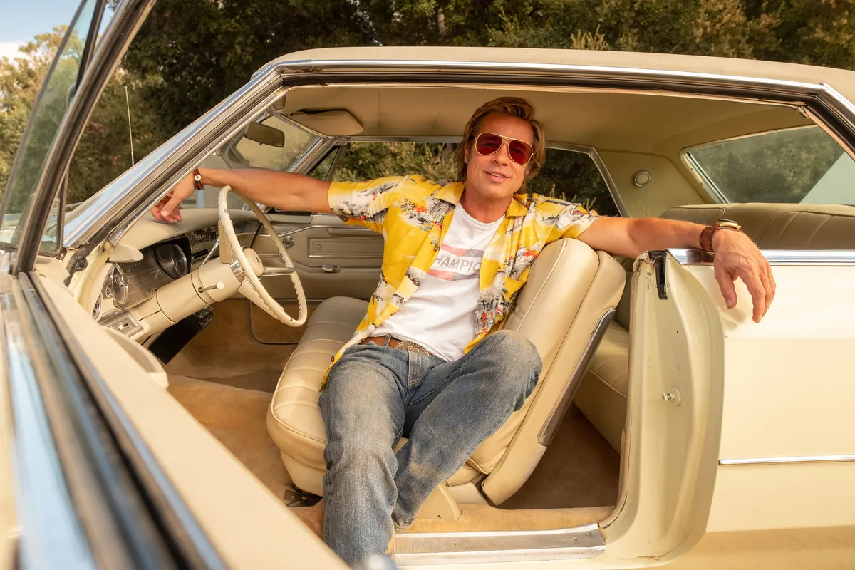 Brad Pitt as Cliff Booth, looking cool and casual, from the movie.