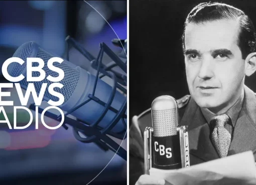 A classic vintage microphone standing in a dark radio studio.