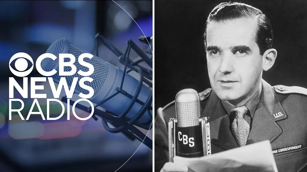 A classic vintage microphone standing in a dark radio studio.