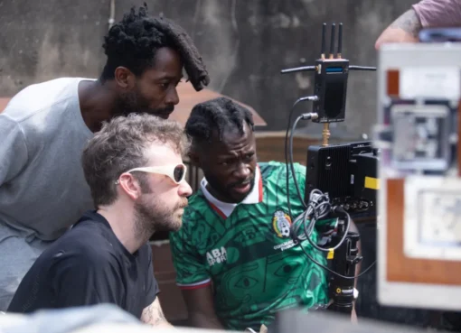 A vibrant still from the film 'Clarissa,' showing a character in a colorful Lagos street setting.