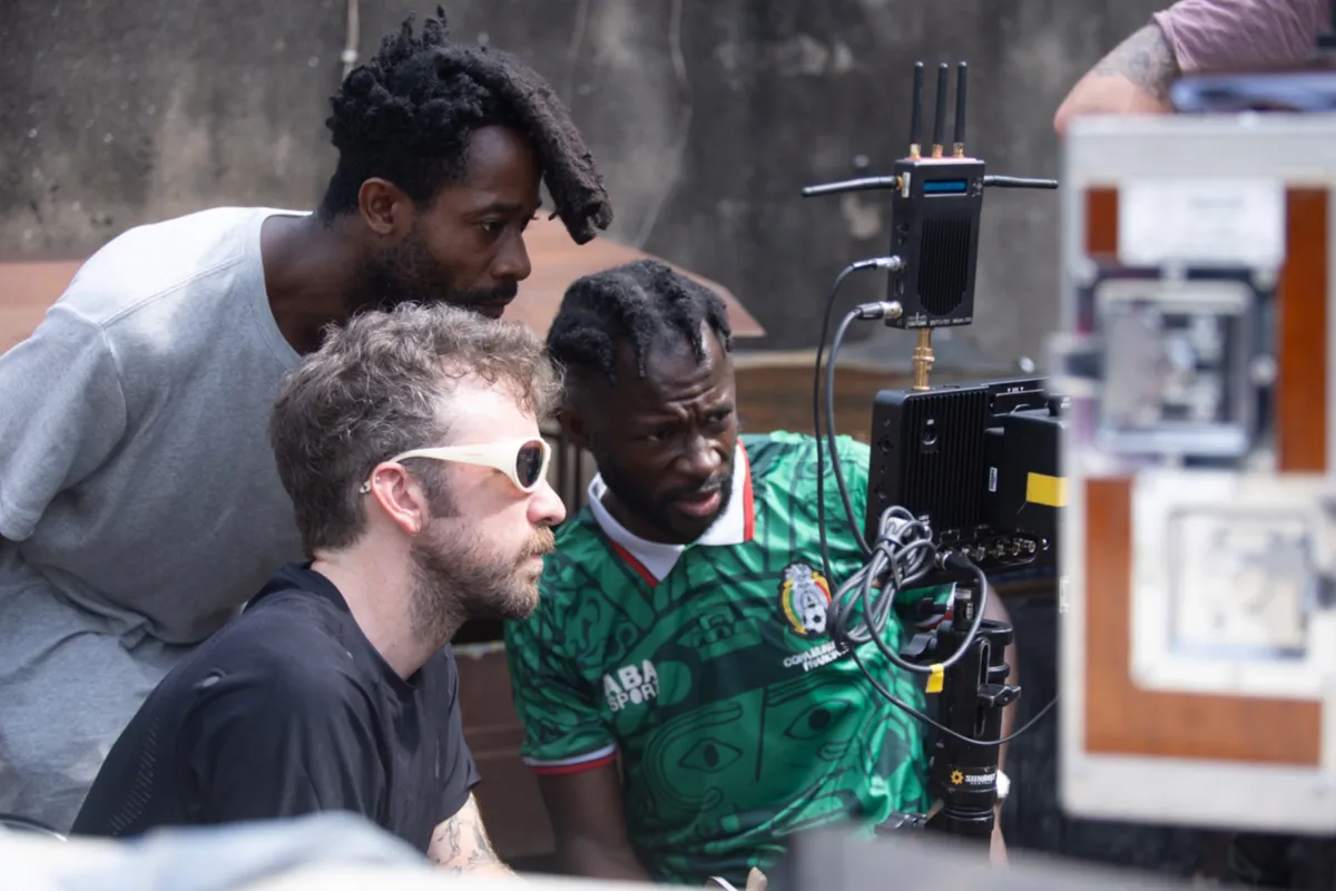 A vibrant still from the film 'Clarissa,' showing a character in a colorful Lagos street setting.