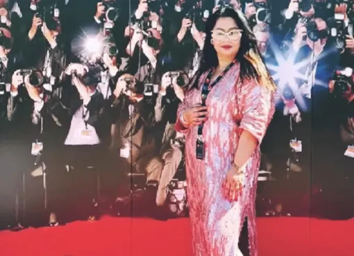 Faridi Eram standing at the Cannes Film Festival, smiling, representing India.