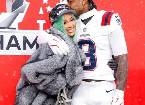 Cardi B and Stefon Diggs smiling and showing affection at a Mother's Day event.